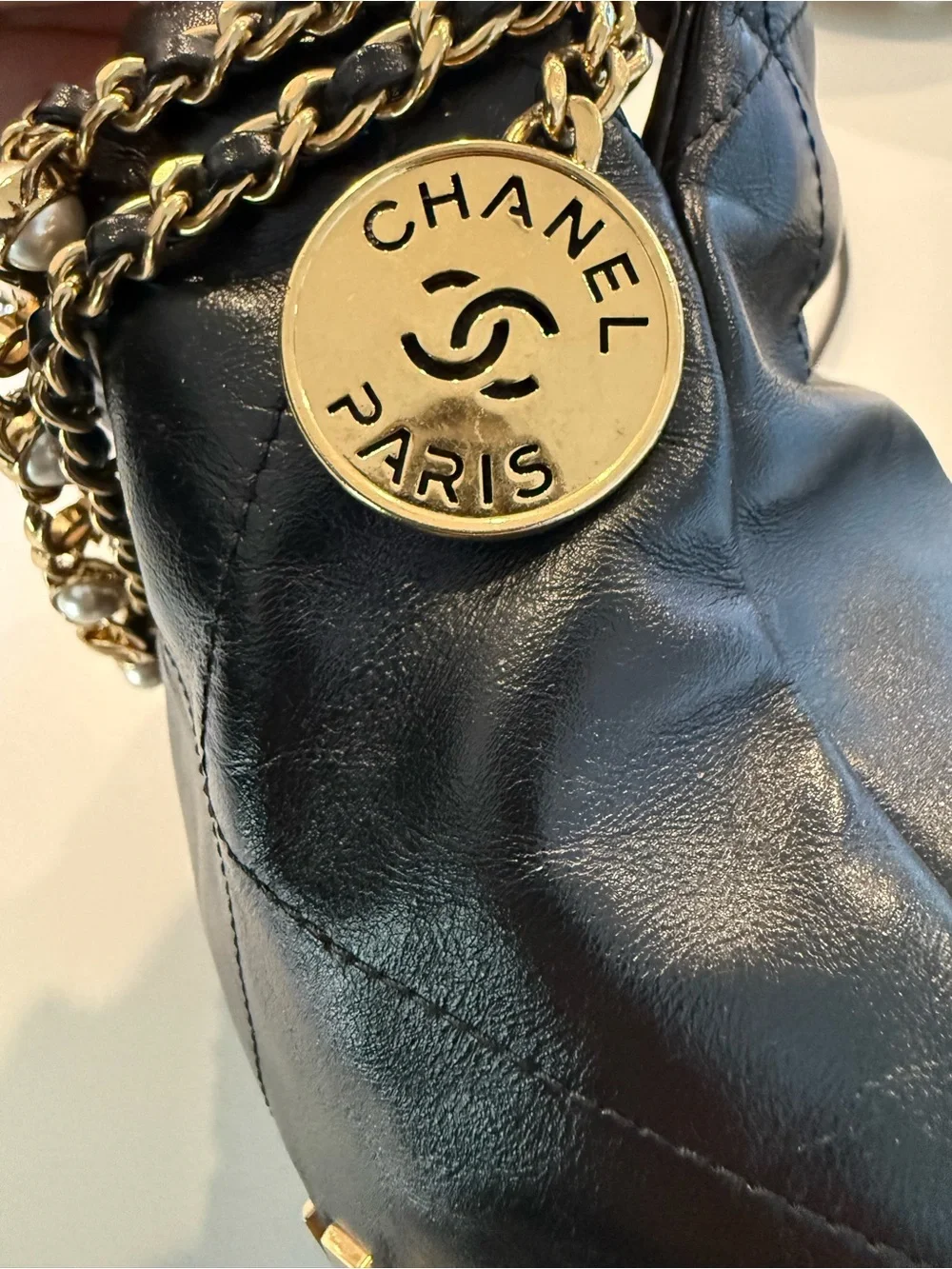 CHANEL 22 Black Quilted Leather Crossbody with Pearl-Trim Chain